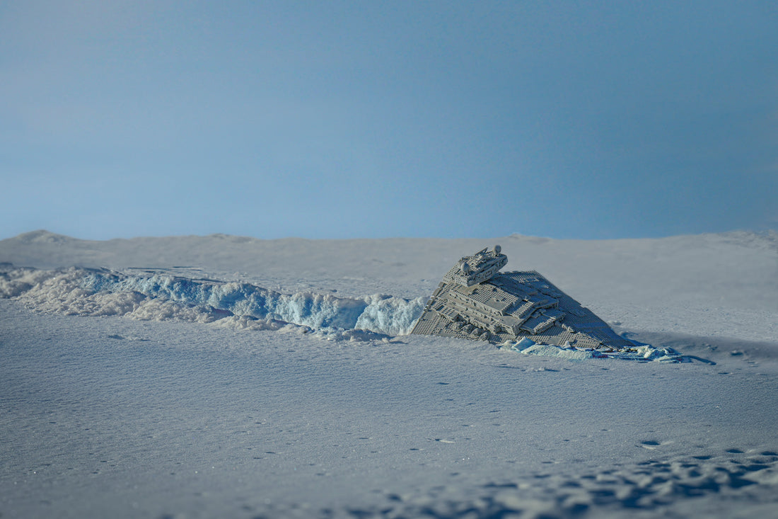 A toy photograph of a crashed Lego Star Destroyer in the snow.
